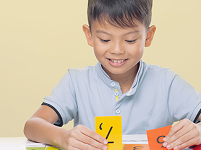 Child interacting with number flash cards during a tuition lesson at The Learning Lab