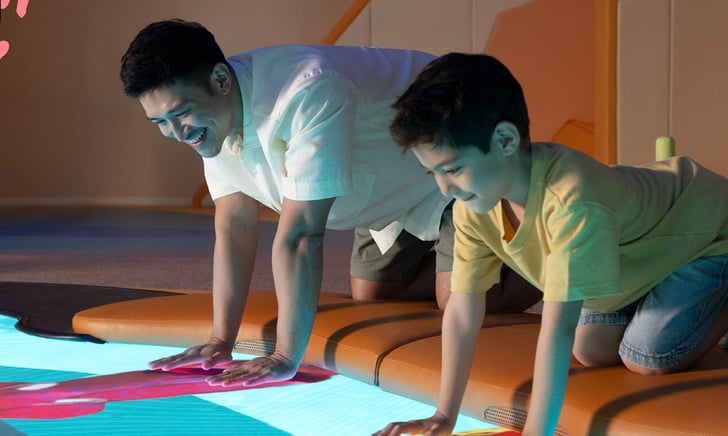 Children and parents playing in Curiosity Cove at Mandai Wildlife Reserve, an indoor nature-themed learning playscape.