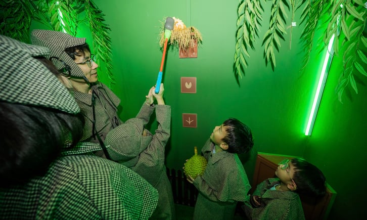 Children taking part in a kid-friendly escape room experience focused on teamwork and problem-solving.