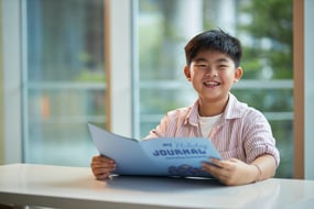Primary student at The Learning Lab reading through English worksheet