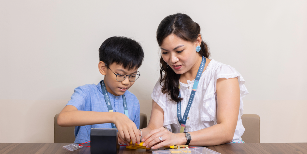 Primary student at The Learning Lab having a personalised tuition lesson with their teacher to build confidence for PSLE